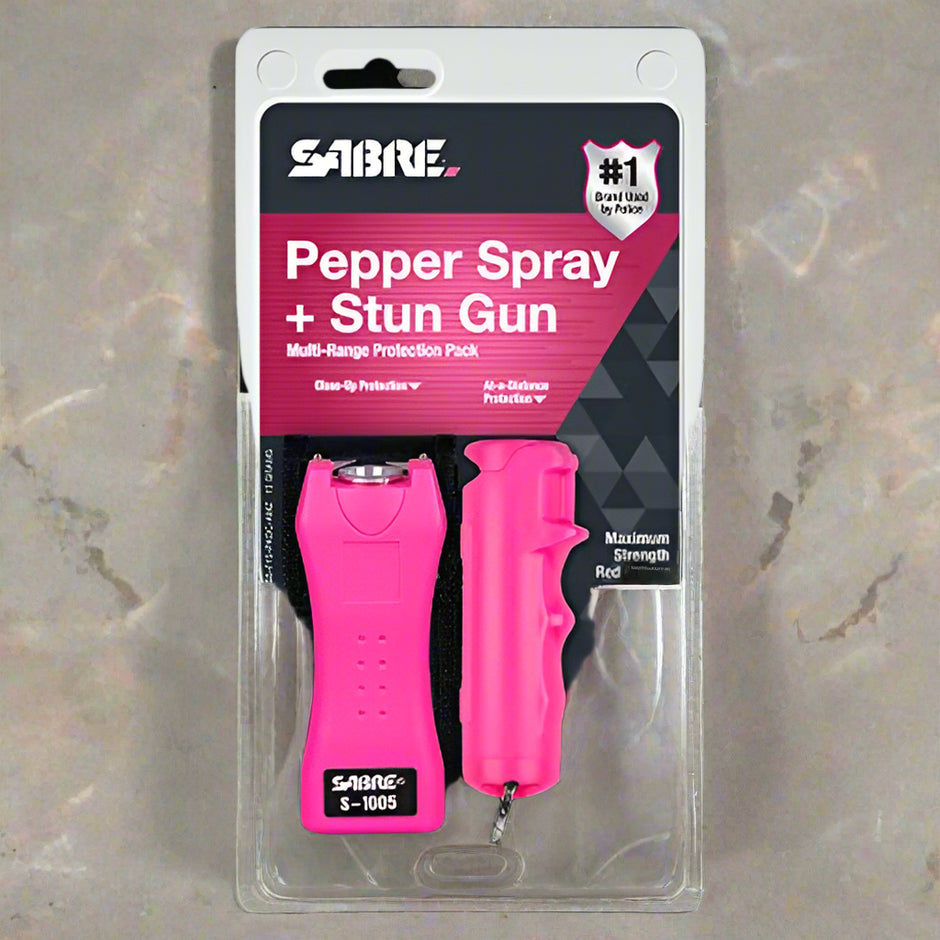 SABRE pepper spray and stun gun set in pink packaging on a white background