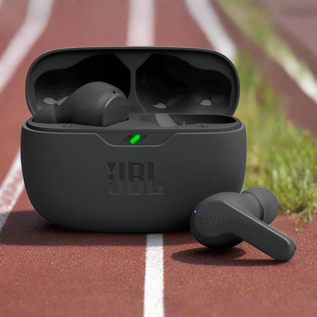 Black JBL wireless earbuds with charging case displayed being charged