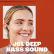 Woman wearing a JBL earbud with 'JBL Deep Bass Sound' text 