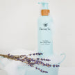 Blue bottle of Timeless Babe hair and body wash with lavender flowers Water-Free
