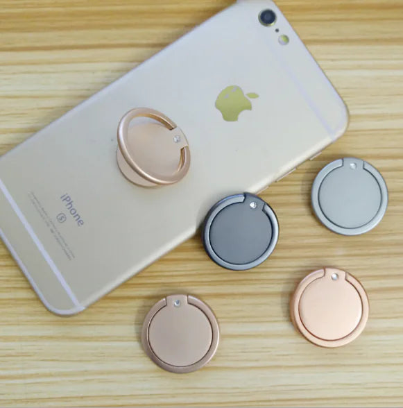 Phone case with multiple ring holders on a wooden surface