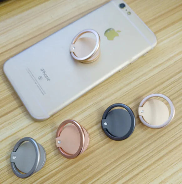 Phone with multiple colored ring holders on a wooden surface